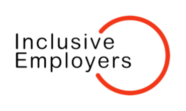Inclusive Employers Logo. Black text and red circle on transparent background.